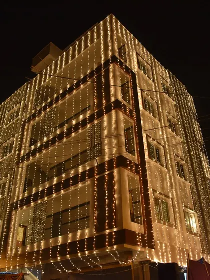 We also capture the ambiance of your celebration, like this shot of a building beautifully illuminated with fairy lights for a wedding.