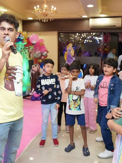 Leading a group of kids in a fun party game. I have a wide repertoire of games suitable for different age groups.