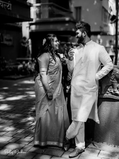 A relaxed, candid black and white shot of the couple enjoying a moment together.