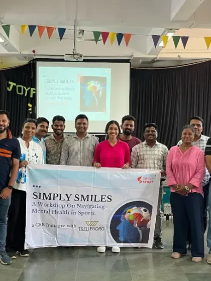 The group of coaches from The Akanksha Foundation, holding our 'Simply Smiles' banner. We believe that mentally healthy coaches are better equipped to create positive and resilient sporting environments.