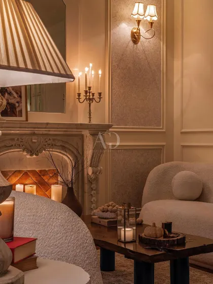 The interplay of light and shadow in this candlelit lounge. The design uses multiple light sources at different heights to create a layered, dynamic, and warm environment.