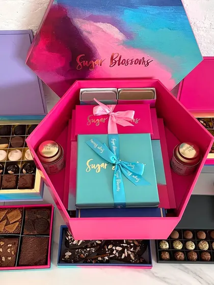 You can even build your own hamper from my extensive Diwali collection. This large hexagonal box can be filled with an assortment of smaller boxes containing brownies, cookies, nuts, and chocolates, creating a truly personalized and impressive gift.