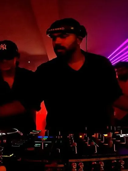 A focused shot of me and other DJs mixing together in a multi-artist showcase, demonstrating my ability to collaborate and perform back-to-back sets.