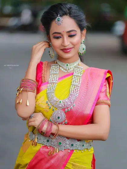 This model is wearing a grand AD and emerald set, perfect for a vibrant sangeet or reception look.