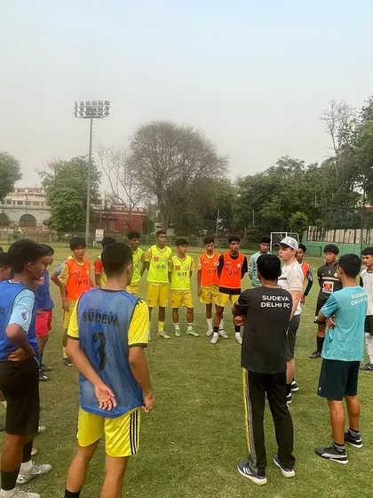 A training session in progress on the main ground. The camp involves various age groups and teams, creating a dynamic and energetic atmosphere.