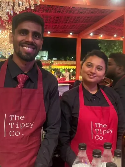 Two of our team members, a male and female bartender, ready to serve at a wedding. Our diverse team is ready to handle events of any scale.