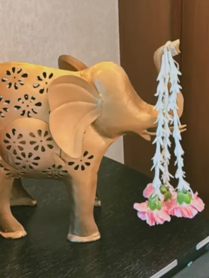 I love incorporating unique decor pieces into my designs. This beautiful elephant figurine, adorned with a simple garland of fresh flowers, adds a touch of traditional charm and elegance.