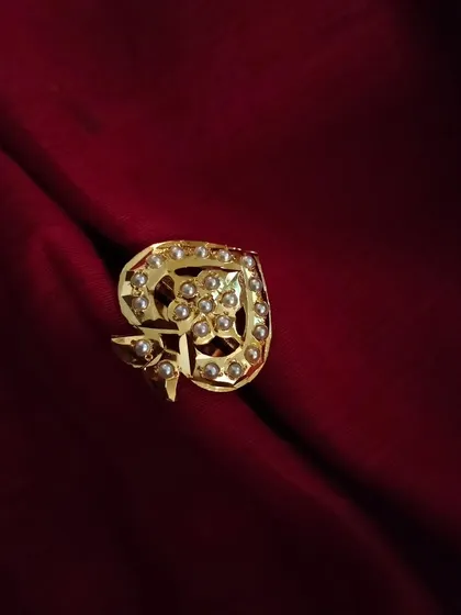 A different perspective of the "Parn" adjustable Jadau ring, showcasing the intricate gold work and the arrangement of pearls. It’s a subtle yet beautiful piece.