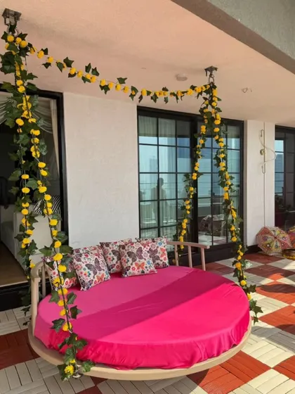 For this Mehendi, I installed a large circular swing decorated with yellow marigold garlands. It serves as a comfortable and stylish seating option for the bride.