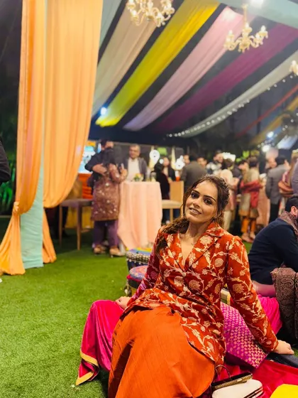 Smiling and soaking in the festive atmosphere. The vibrant colors of my outfit feel right at home in this beautifully decorated Lohri celebration.