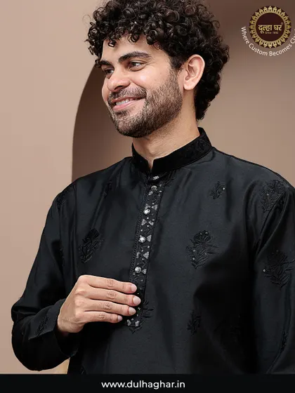 Wear the royalty in fabric. A close-up of a model in a black kurta with subtle embroidery and a detailed placket.