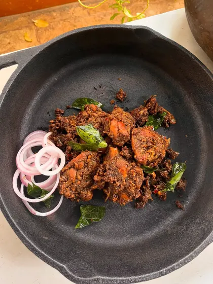 My Kovalam Smoky Roasted Chicken, also known as Chicken Chuttathu. The chicken is marinated in traditional stone-ground spices and then smoke-cooked for a robust, spicy flavor that is absolutely drool-worthy.