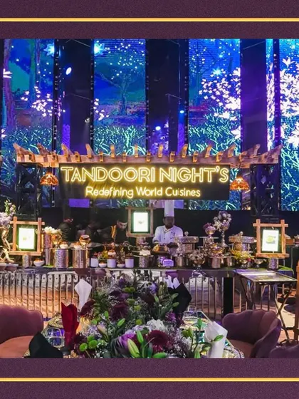 Another view of our impressive live station, showcasing the blend of floral decor, professional chefs, and elegant serveware that defines our catering service.