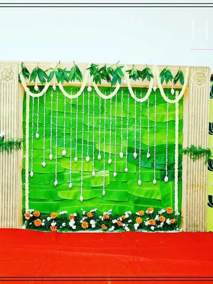 This image showcases the backdrop I designed for a traditional baby shower. The use of natural elements and sacred motifs like the lotus is central to my decoration style for these events.