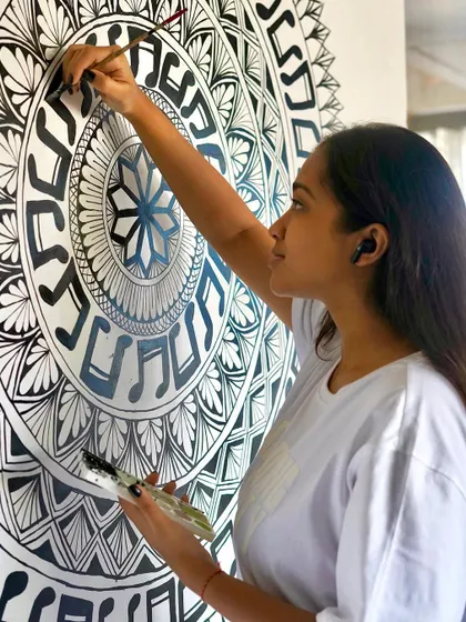 A close up of me painting the music note border on the freehand mandala. It’s all about patience and a steady hand.