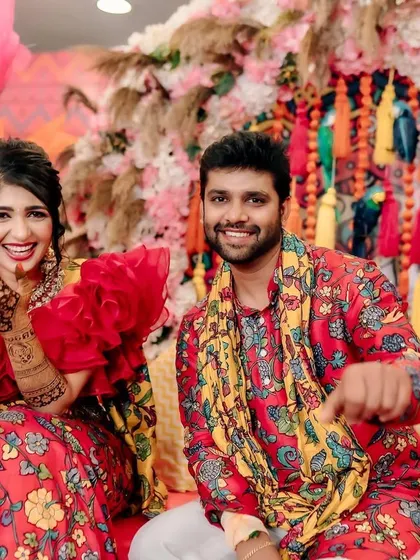 Fun and candid moments from a vibrant Mehendi event. The couple is sharing a laugh, surrounded by the bright, festive atmosphere I designed for their special day.