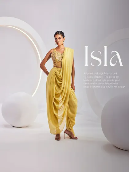 The Isla Saree Set in a vibrant yellow. This dhoti-style pre-draped saree is paired with a detailed corset blouse, offering a bold and fashion-forward take on festive wear.
