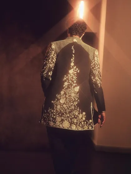 The back of this jacket is just as stunning as the front. This shot highlights the beautiful embroidery that flows down the spine, ensuring a dramatic exit.