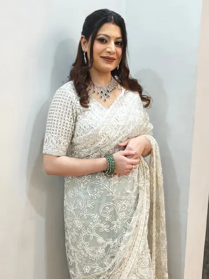 The full look for this wedding guest. She's wearing a beautiful white saree, and we added just enough sparkle to her makeup to match the elegance.