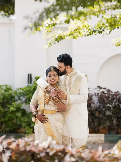 A classic, elegant portrait of the couple on their special day. Dressed in beautiful ivory and gold, their joy and affection are palpable in this tender embrace.
