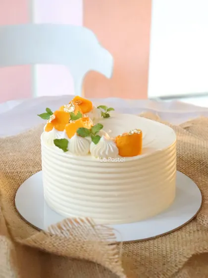 A full view of the elegant Alphonso mango cake, a seasonal favorite.