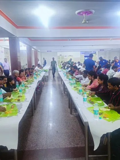 Our team serving a large gathering at ANR Bhavan in Kasturinagar. The long tables are set for a traditional banana leaf meal, showcasing our ability to manage large-scale wedding catering.