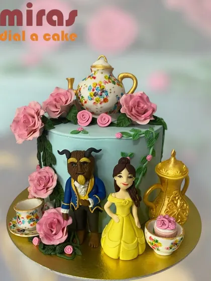 A tale as old as time, this Beauty and the Beast cake is truly enchanting. It features sculpted figures of Belle and the Beast, along with Mrs. Potts and Chip, surrounded by romantic pink roses.
