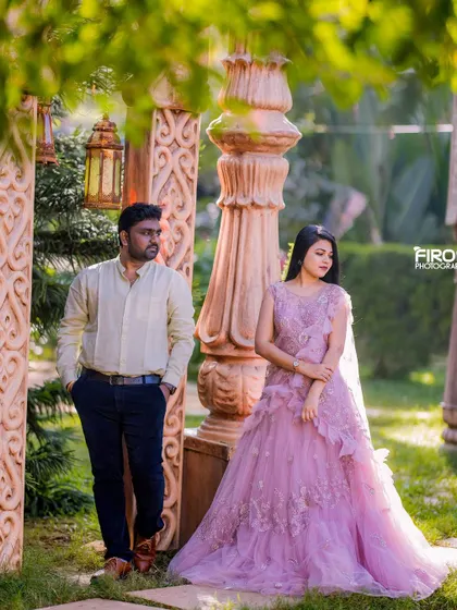 A soft and romantic portrait in the garden. The delicate lavender gown with its intricate details adds a touch of elegance to this quiet moment between the couple.