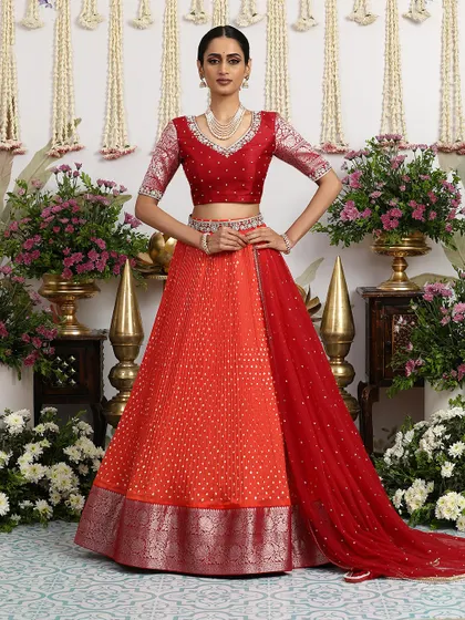 A classic red and orange Bandhani lehenga, a vibrant and joyful choice for any bridal celebration.