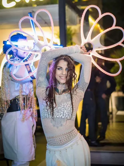 A duo LED performance featuring two artists in coordinated white outfits with different light props. We can mix and match acts to create a custom show for your event.