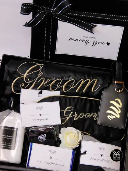 A sophisticated survival kit for the man of the hour. This 'Groom' hamper is curated with essentials like a personalized satin robe, a sleek luggage tag, and other goodies to help him relax and prepare for the big day.