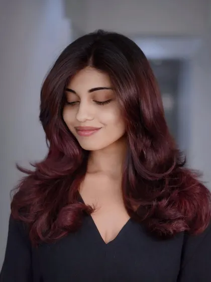 Power in every pigment. This look features a deep, velvety red ombre, transitioning from a darker root to vibrant ends.