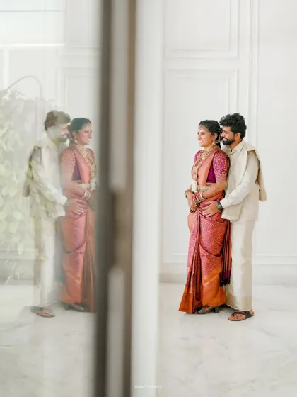An artistic shot using reflections to create a dreamy and romantic portrait of the couple.