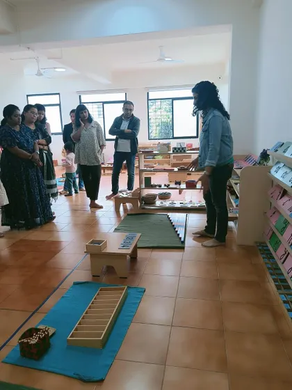 A teacher presents the language curriculum to parents during an orientation.