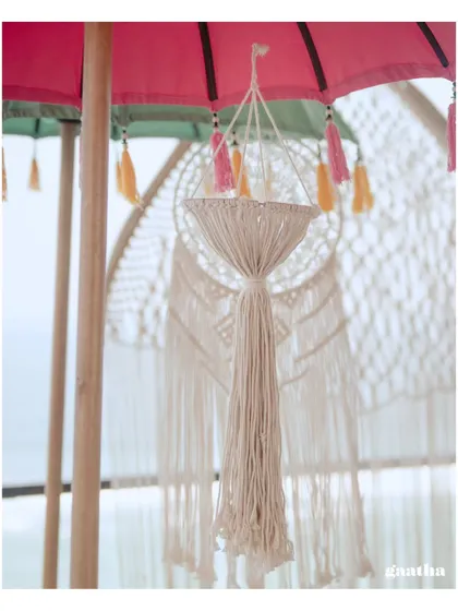 A close-up of a delicate macrame chandelier, one of the many handcrafted details that added to the bohemian vibe of the Bali wedding.