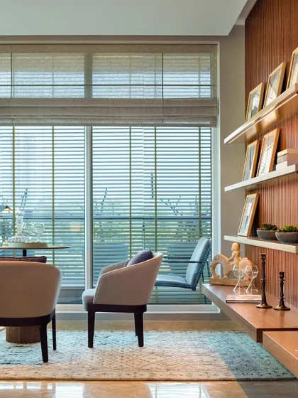 A comfortable seating nook by a large window in the Elevate residence, perfect for reading or enjoying the view.