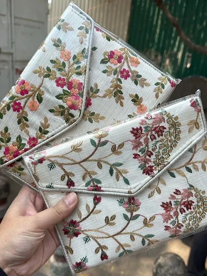 Two beautiful envelope clutches with different floral embroidery patterns. These are lightweight and just the right size for your phone and lipstick.