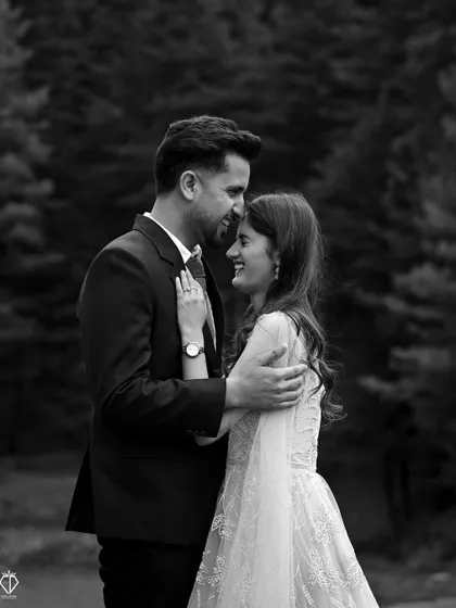 A beautiful black and white close-up, capturing the laughter and joy of an intimate embrace. The focus is purely on their emotion.