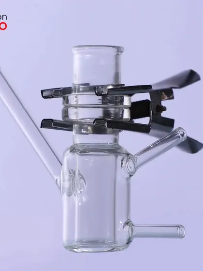 A glass instrument with a metal clip, showing how we can clearly photograph products made of multiple materials.