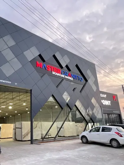 For this commercial facade for Master Granitto, we used angular forms and a sleek, dark ACP cladding to create a bold, modern identity. The design plays with geometry and reflection, making the building a landmark in its commercial environment.