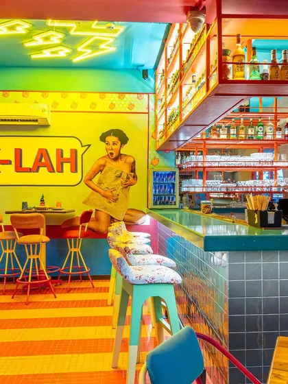 This composition at The Fatty Bao links the bar area to the seating, with the neon lights and wall art creating a path for the eye. It's a commercial interior shot that shows both the vibe and the layout.