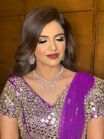 Bold and beautiful for Yesha's sangeet. I created a dramatic look with a deep berry lip and enchanting smokey eyes to match her vibrant purple mirror-work lehenga.