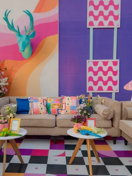 I created vibrant and comfortable lounge areas that combined eclectic patterns, bold colors, and whimsical props. This space shows a mix of checkerboard floors, patterned cushions, and quirky animal sculptures, ensuring every corner was visually stimulating.