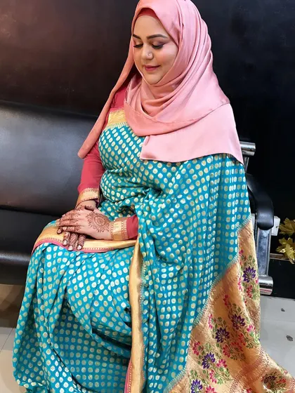 The same client, showing her full look. The combination of the pink hijab and the blue and gold saree is stunning.