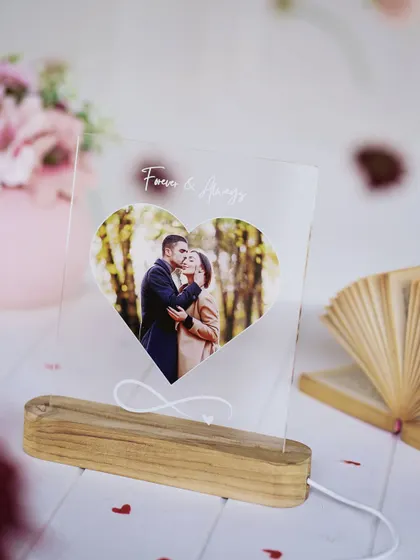 The heart-shaped LED lamp, unlit, showing the clear acrylic and the elegant engraving.