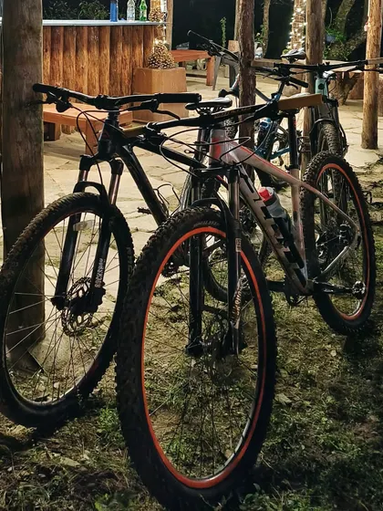 A couple of hardtail mountain bikes parked after a day's ride. Cycling tours are the best way to truly experience a new place up close.