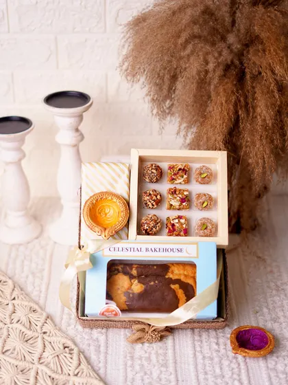 The 'Pure Indulgence Hamper' for Diwali, featuring a tea cake, handmade mithai, and a ceramic aroma diffuser.