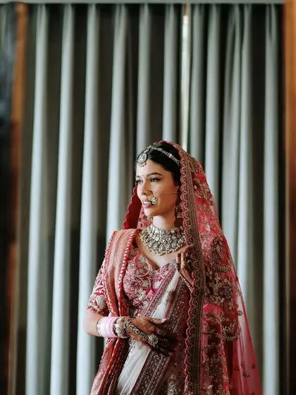 Another angle of the bride looking at her reflection, capturing a moment of calm before the ceremony begins.