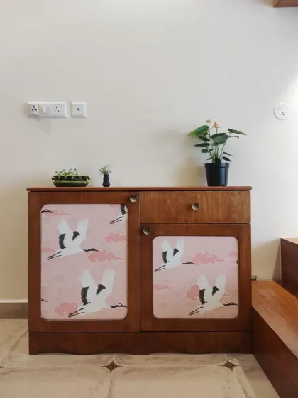This charming little cabinet with crane-print doors is the perfect companion to the wall-mounted bookcase, continuing the theme of elegance and eternal love symbolized by the cranes.