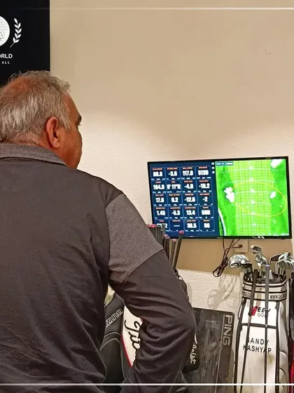 Another angle of a client studying his swing data. The numbers don't lie, and they provide the foundation for real improvement.